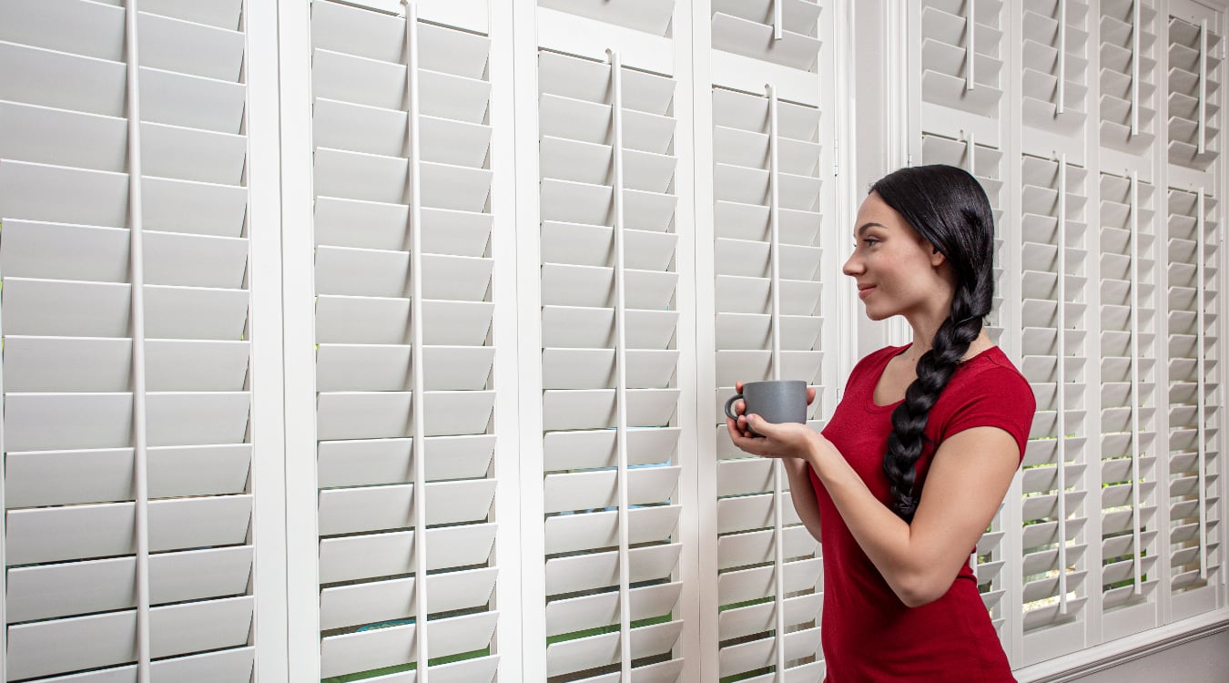 Woman admiring plantation shutters